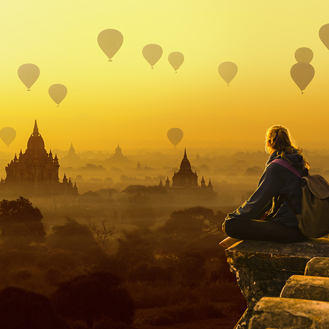 Tourist girl and hot air balloons in Bagan, Myanmar